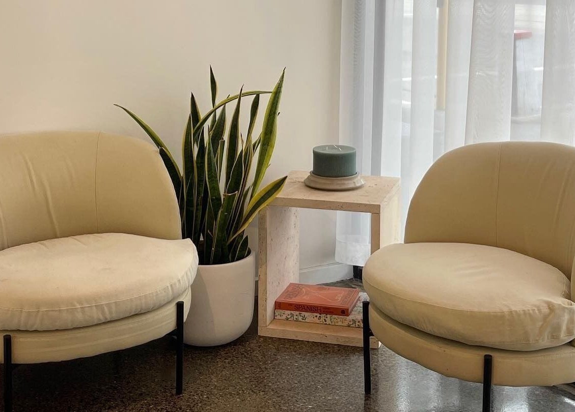 Relaxing beige seating area at Hair by Hustle and Co, Richmond, Victoria, AU.