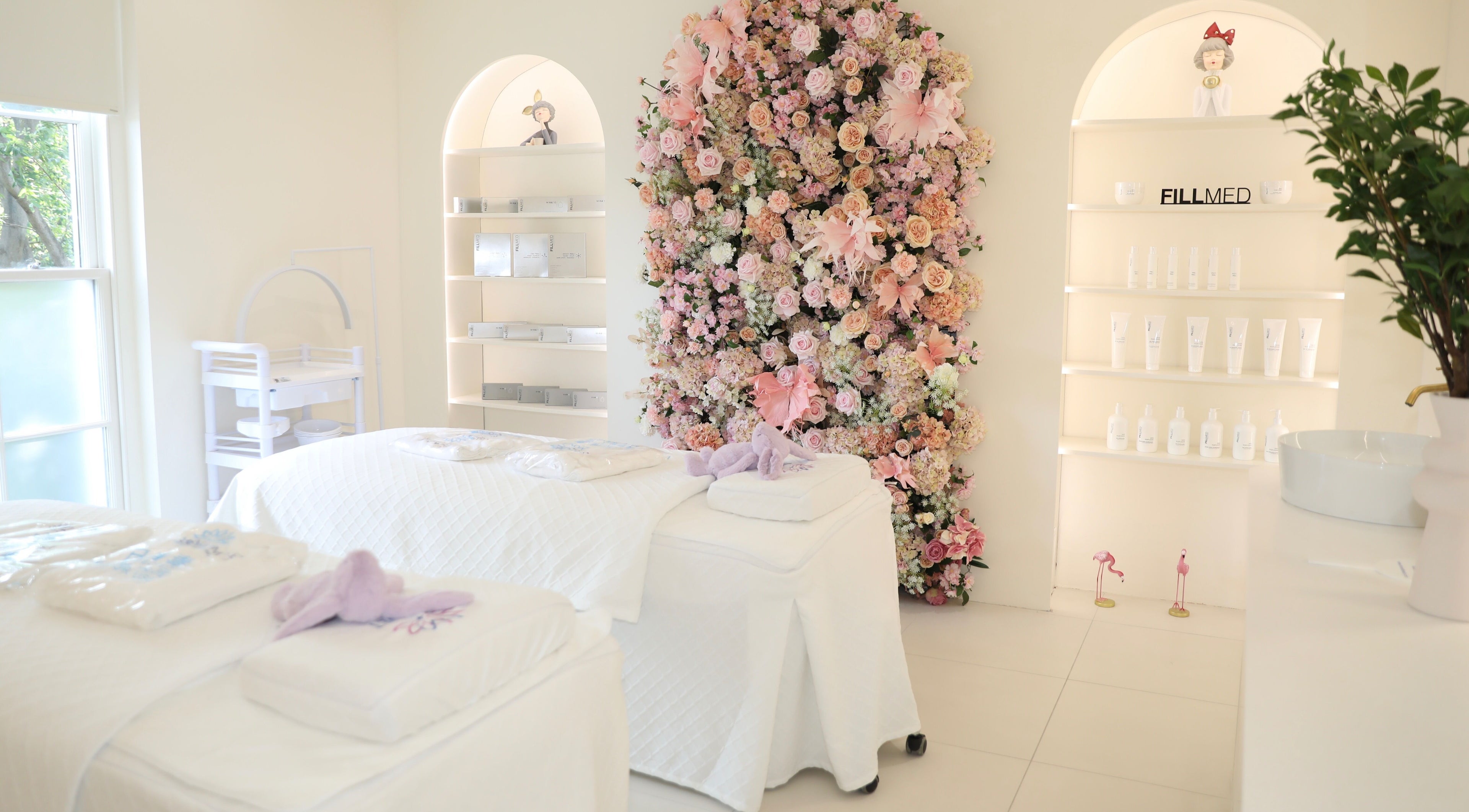 Elegant spa room at Monet Beauty Clinic, London, England, GB, featuring floral decor and treatment tables.