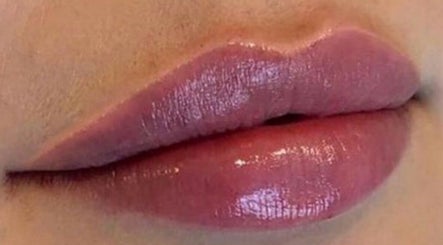 Glossy pink lips at Redefined Aesthetics & Skin in Bargoed, Wales, GB, showcasing vibrant beauty treatments.