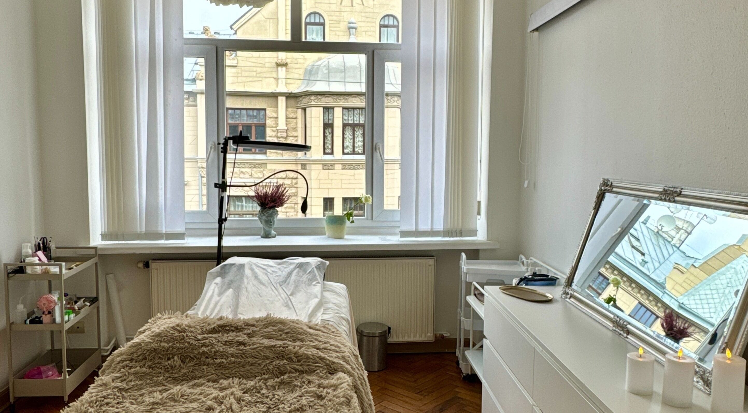 Calming treatment room at Madara Z Beauty with window view in Rīga, LV offering relaxation.