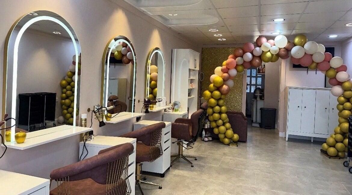 Stylish interiors of Jayliee Hair and Beauty, London, England, GB showcasing elegant salon chairs and mirrors.