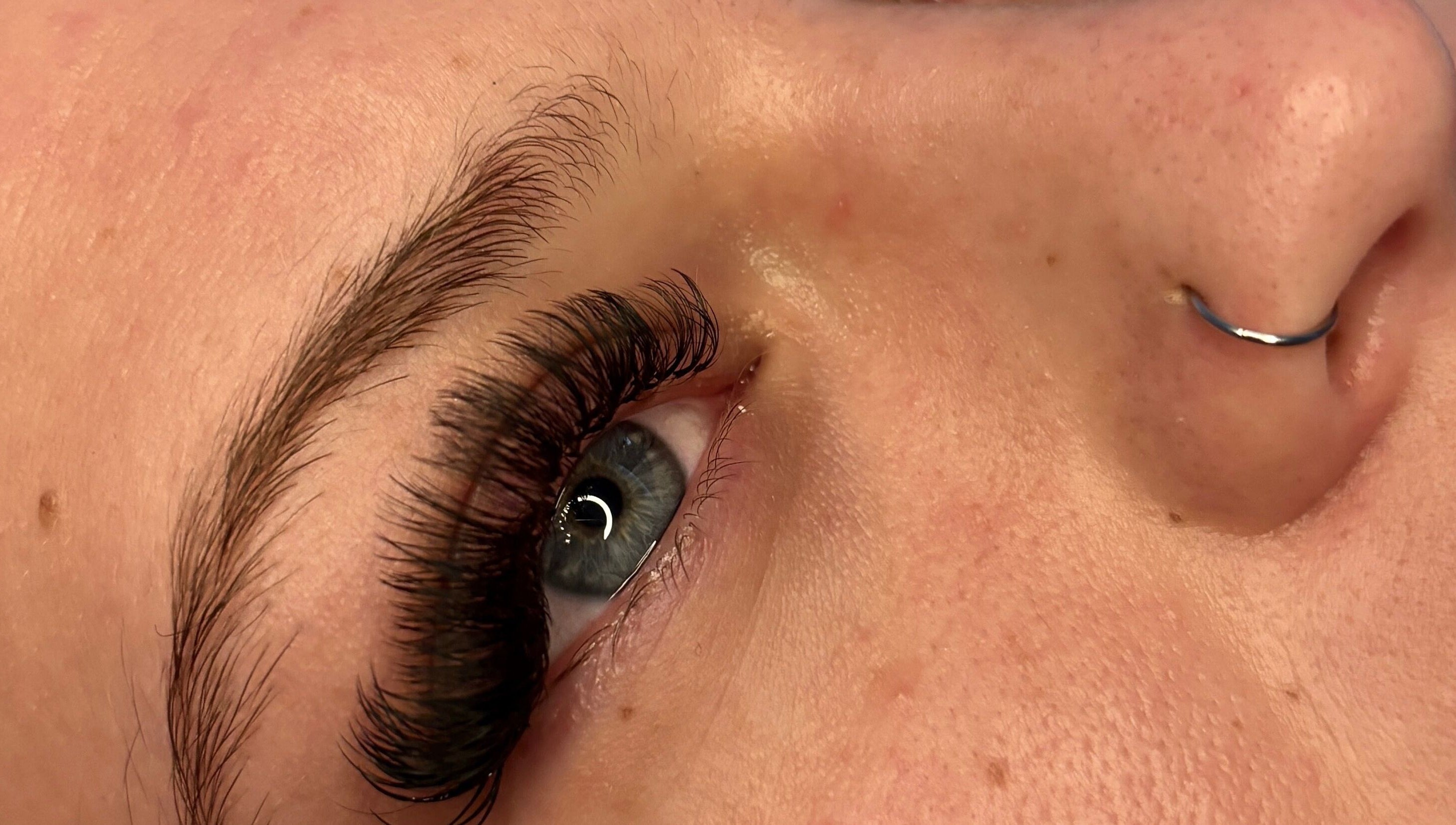 Close-up of eyelash extensions at House Of Gaia, Newmarket, England, GB. Highlighting exquisite detail and care.