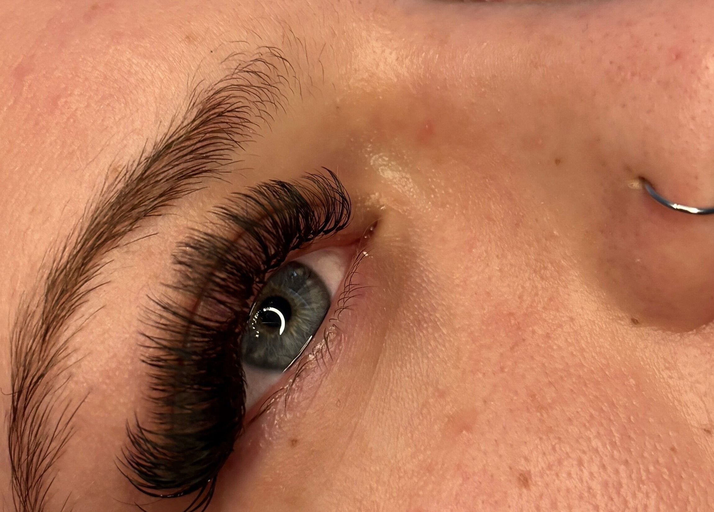 Close-up of eyelash extensions at House Of Gaia, Newmarket, England, GB. Highlighting exquisite detail and care.