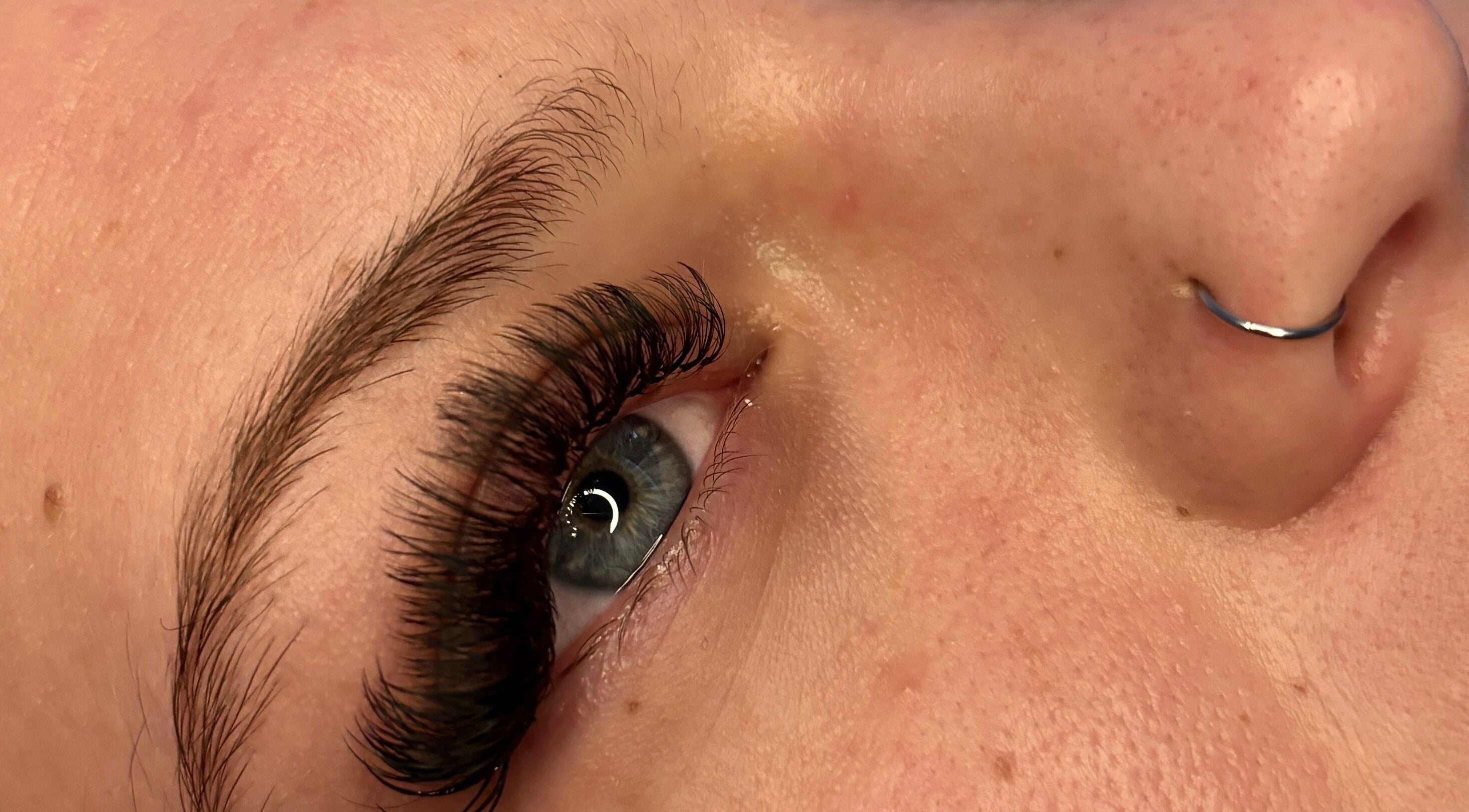 Close-up of eyelash extensions at House Of Gaia, Newmarket, England, GB. Highlighting exquisite detail and care.