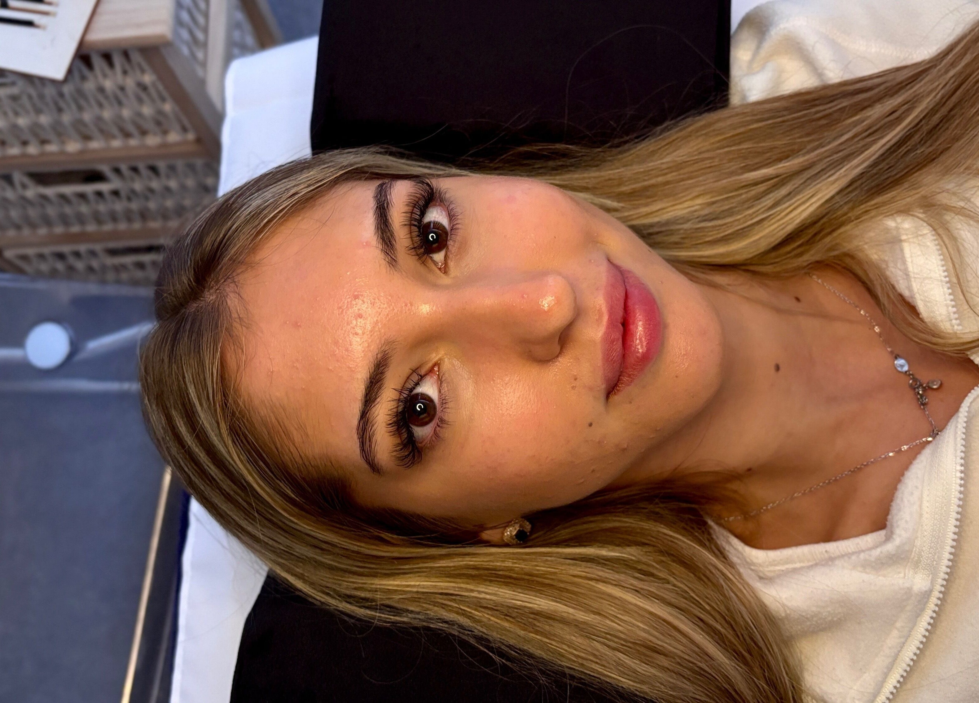 A client enjoys a serene facial at House Of Gaia, Newmarket, England, GB, showcasing glowing skin.