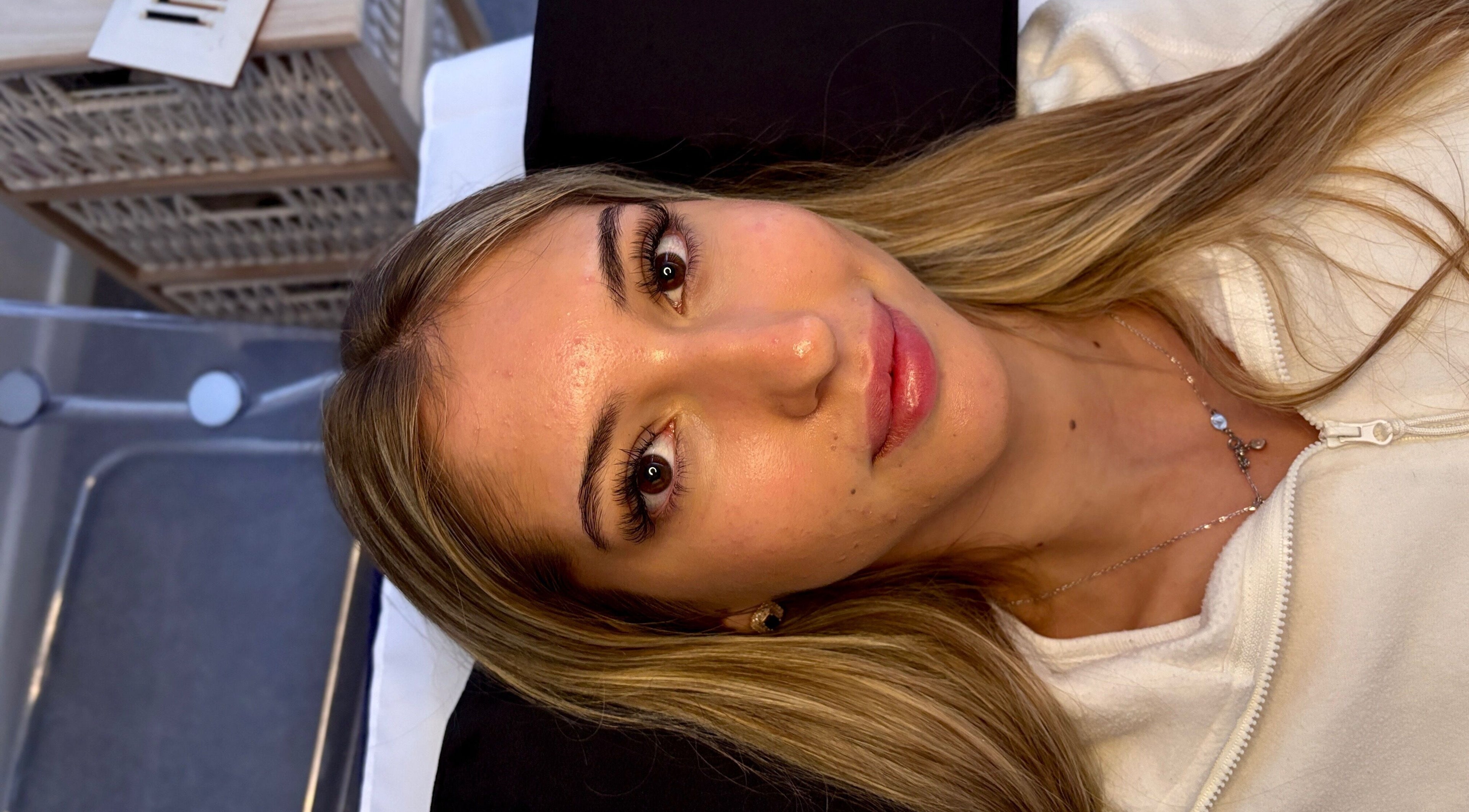 A client enjoys a serene facial at House Of Gaia, Newmarket, England, GB, showcasing glowing skin.