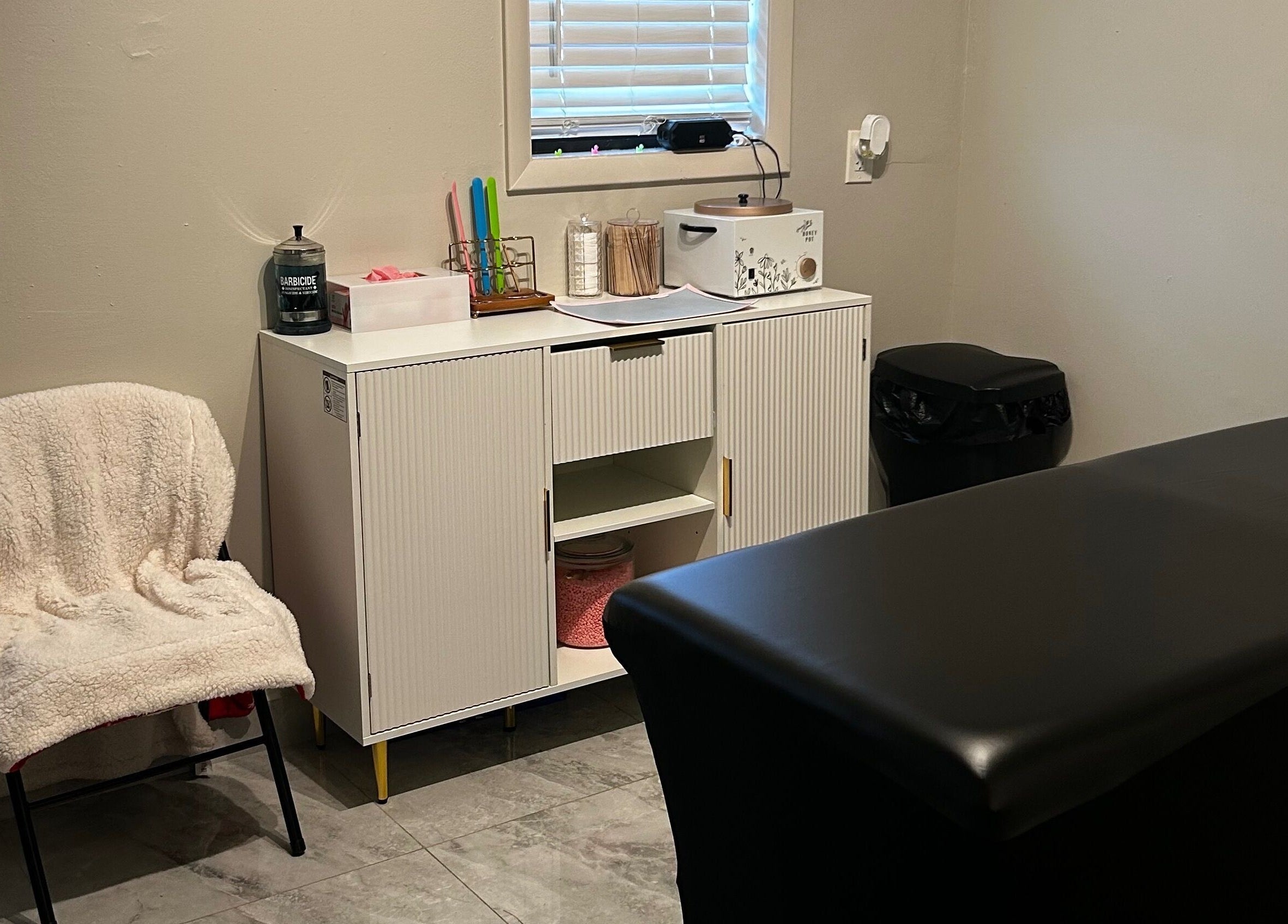 Comfortable waxing room at Waxed by Ky, Fort Myers, Florida, US showcasing modern decor and professional setup.
