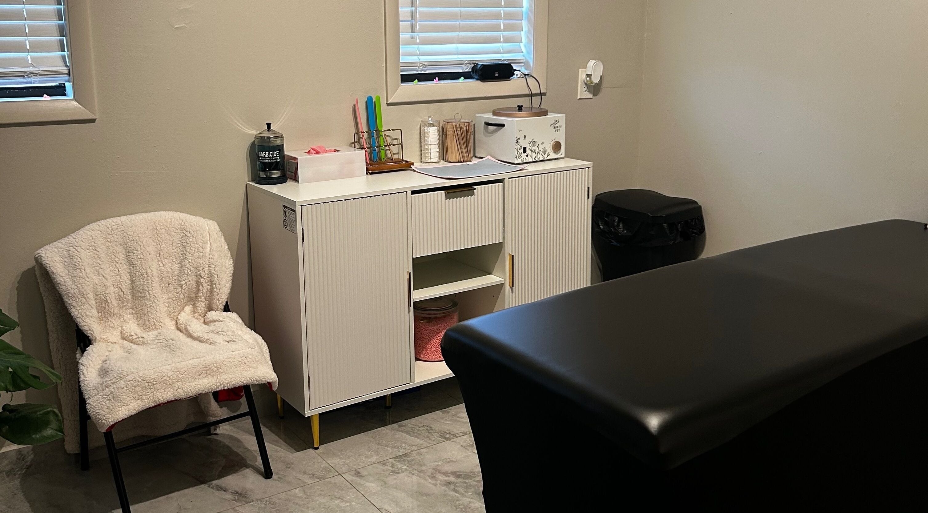 Comfortable waxing room at Waxed by Ky, Fort Myers, Florida, US showcasing modern decor and professional setup.
