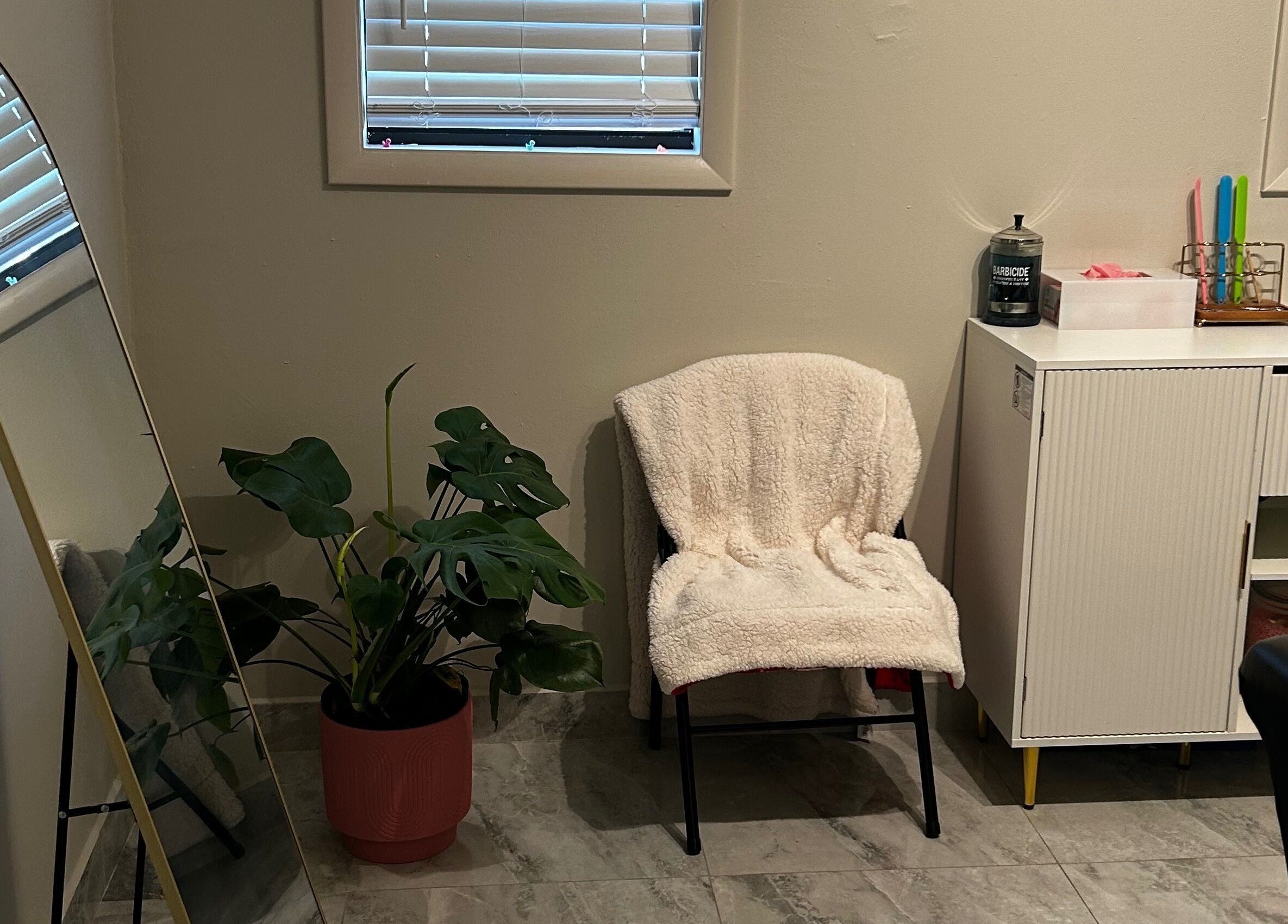 Relaxing chair and plant decor in Waxed by Ky, Fort Myers, Florida, US.