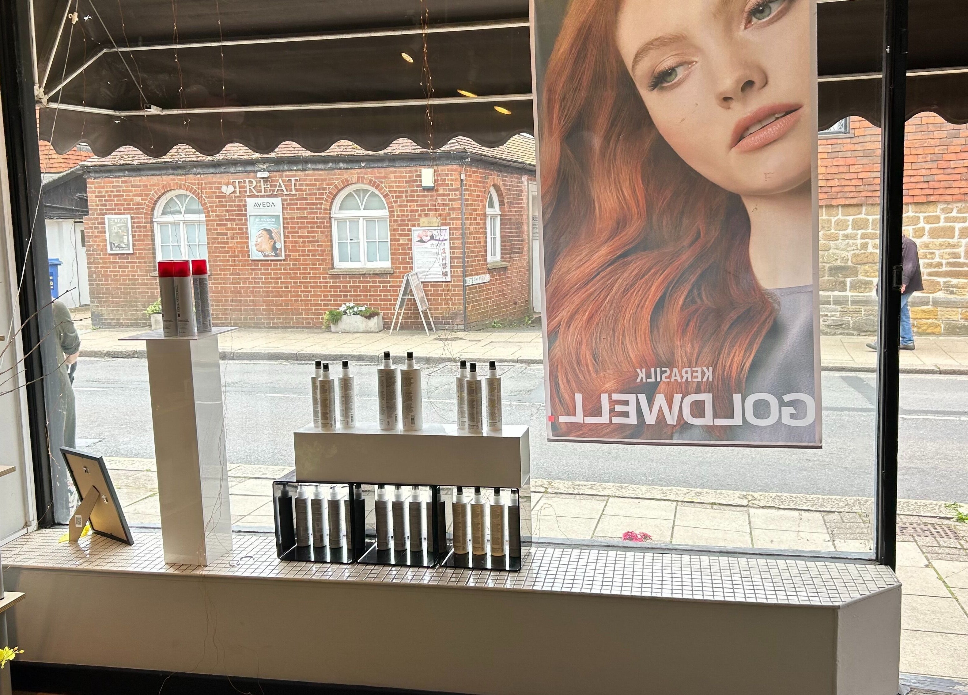Interior window display at Panache Hair and Beauty Salon, Battle, England, GB featuring premium hair products.