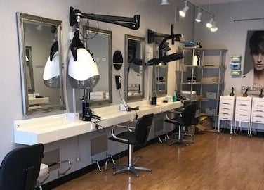 Modern salon interior at Panache Hair and Beauty Salon, Battle, England, GB with stylish mirrors and chairs.