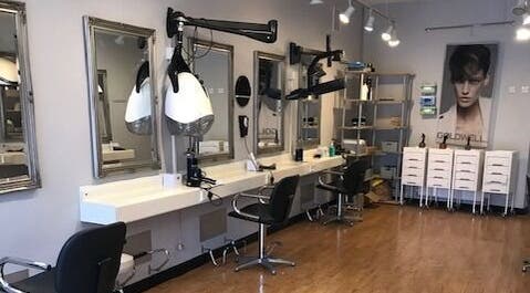 Modern salon interior at Panache Hair and Beauty Salon, Battle, England, GB with stylish mirrors and chairs.