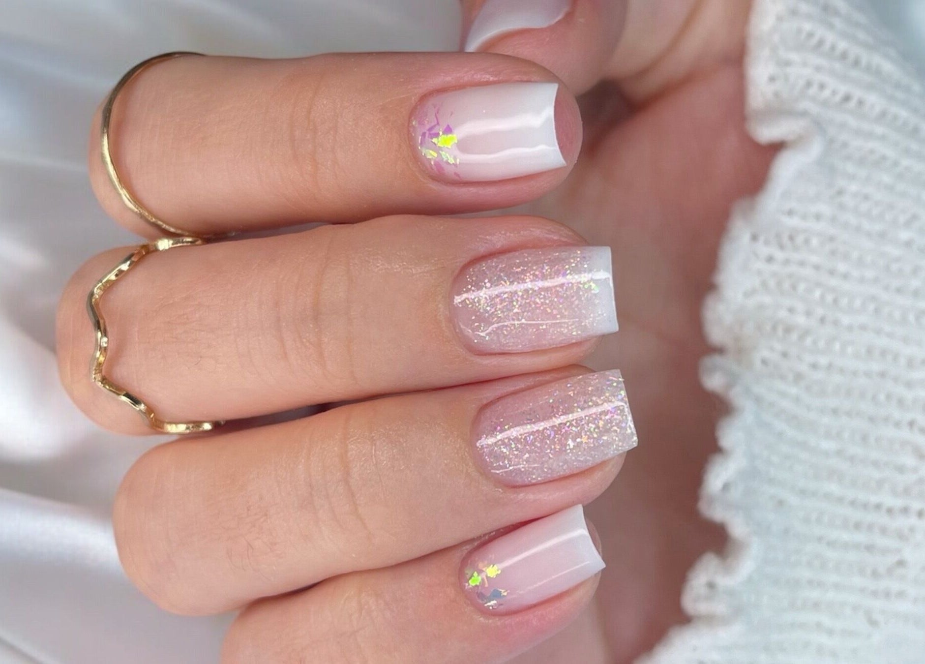 Elegant pink and white glitter nail art at Natalia Bernardes, Ilford, England, GB.
