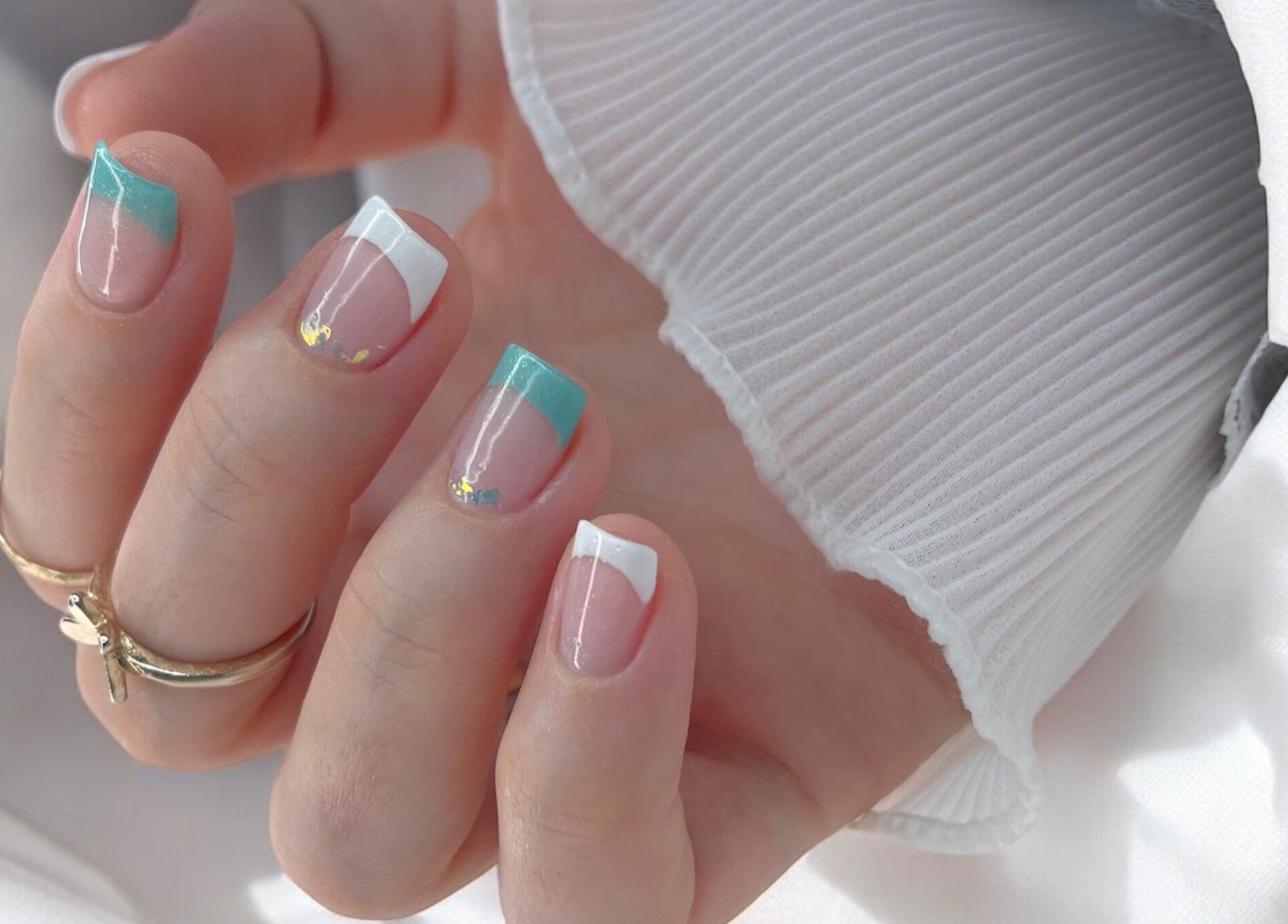 Elegant gel manicure at Natalia Bernardes, Ilford, England, GB featuring turquoise and white tips.