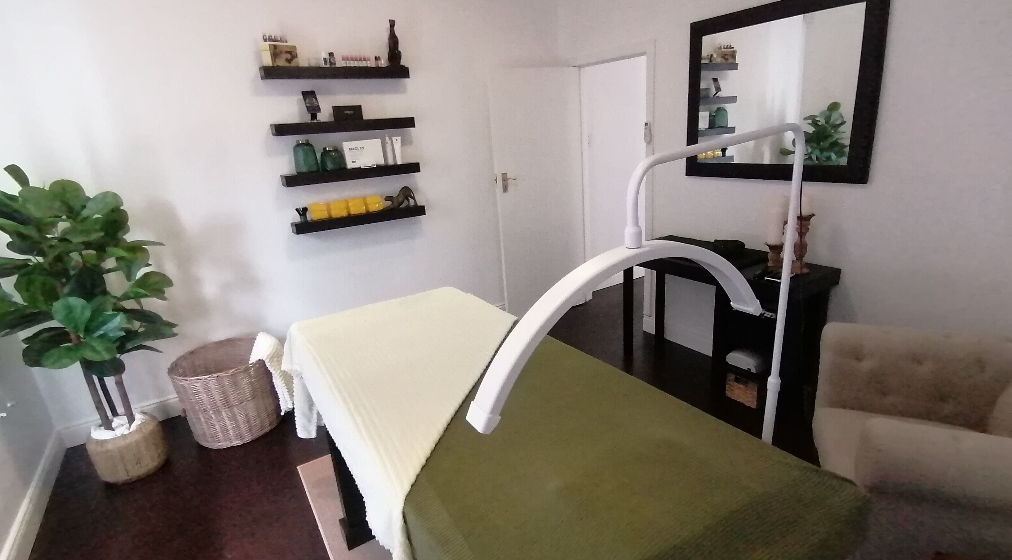 Charlize Smit Aesthetics in Pretoria, Gauteng, ZA. Cozy spa room with treatment bed and greenery.