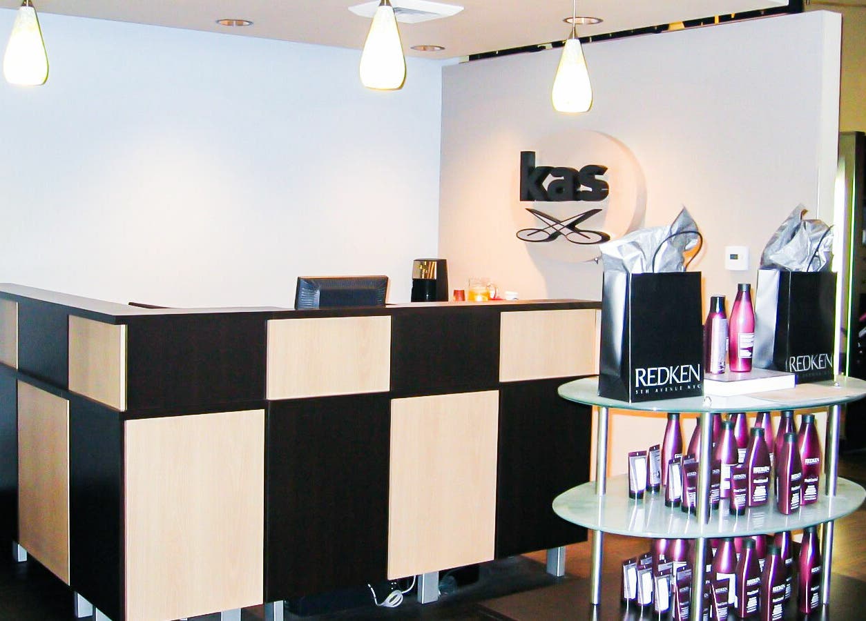 Reception area of Kathy Adams Salon in Buford, Georgia, US with modern decor and Redken products.