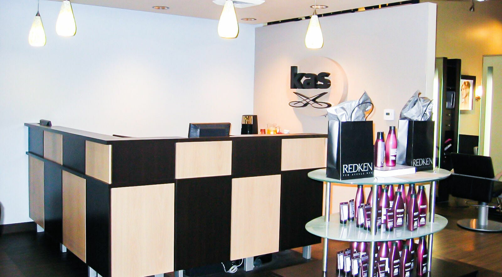 Reception area of Kathy Adams Salon in Buford, Georgia, US with modern decor and Redken products.
