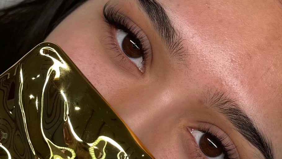 Close-up of styled lashes at Luxe Lash by DK, Newcastle upon Tyne, England, GB with golden accessory.