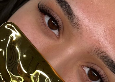 Close-up of styled lashes at Luxe Lash by DK, Newcastle upon Tyne, England, GB with golden accessory.