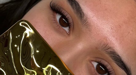 Close-up of styled lashes at Luxe Lash by DK, Newcastle upon Tyne, England, GB with golden accessory.