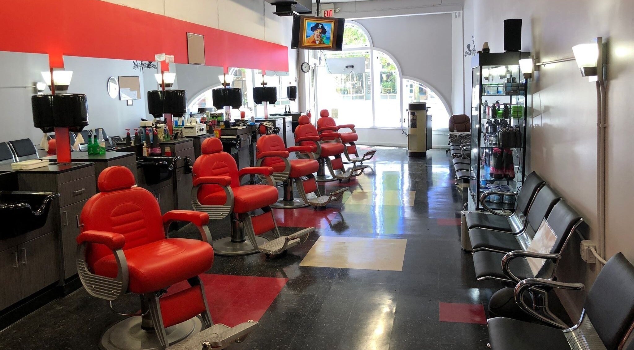 Interior view of Prestige Barbershop, Cleveland, Ohio, US, showcasing modern red barber chairs.