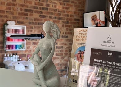 Interior of Daysha Aesthetics in Benoni, Gauteng, ZA featuring a calming sculpture and beauty product display.