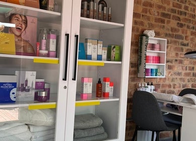 A chic salon corner at Daysha Aesthetics, Benoni, Gauteng, ZA, featuring beauty products and a cozy nail station.