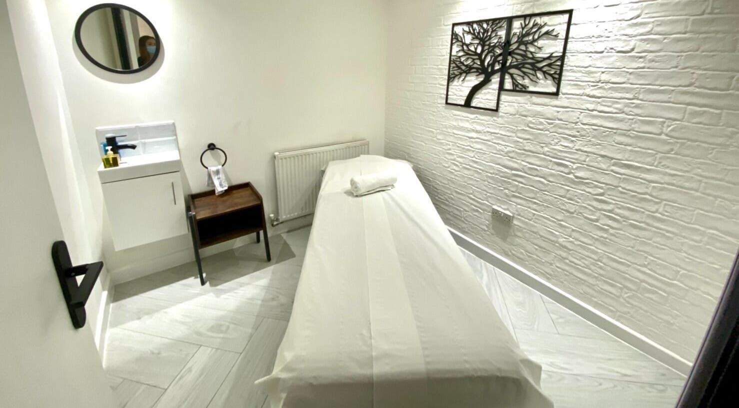 Private massage room at Thai Harmony Spa & Massage, London, England, GB, featuring a serene, minimalist design.