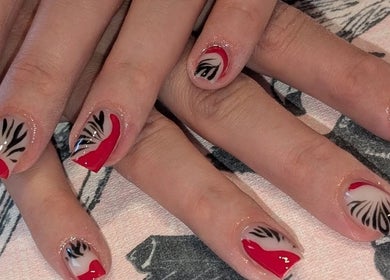 Stylish red and black nail art at J.m.nails in Fair Oak, England, GB. Perfect for a chic look.