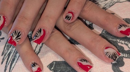 Stylish red and black nail art at J.m.nails in Fair Oak, England, GB. Perfect for a chic look.