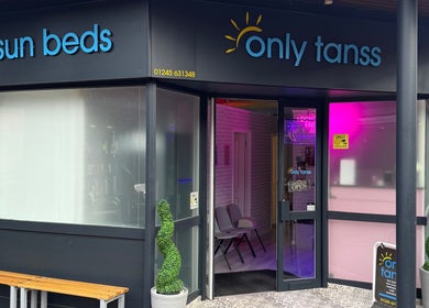 Front view of Only Tans salon in Wickford, England, GB with bright signage and open entrance.