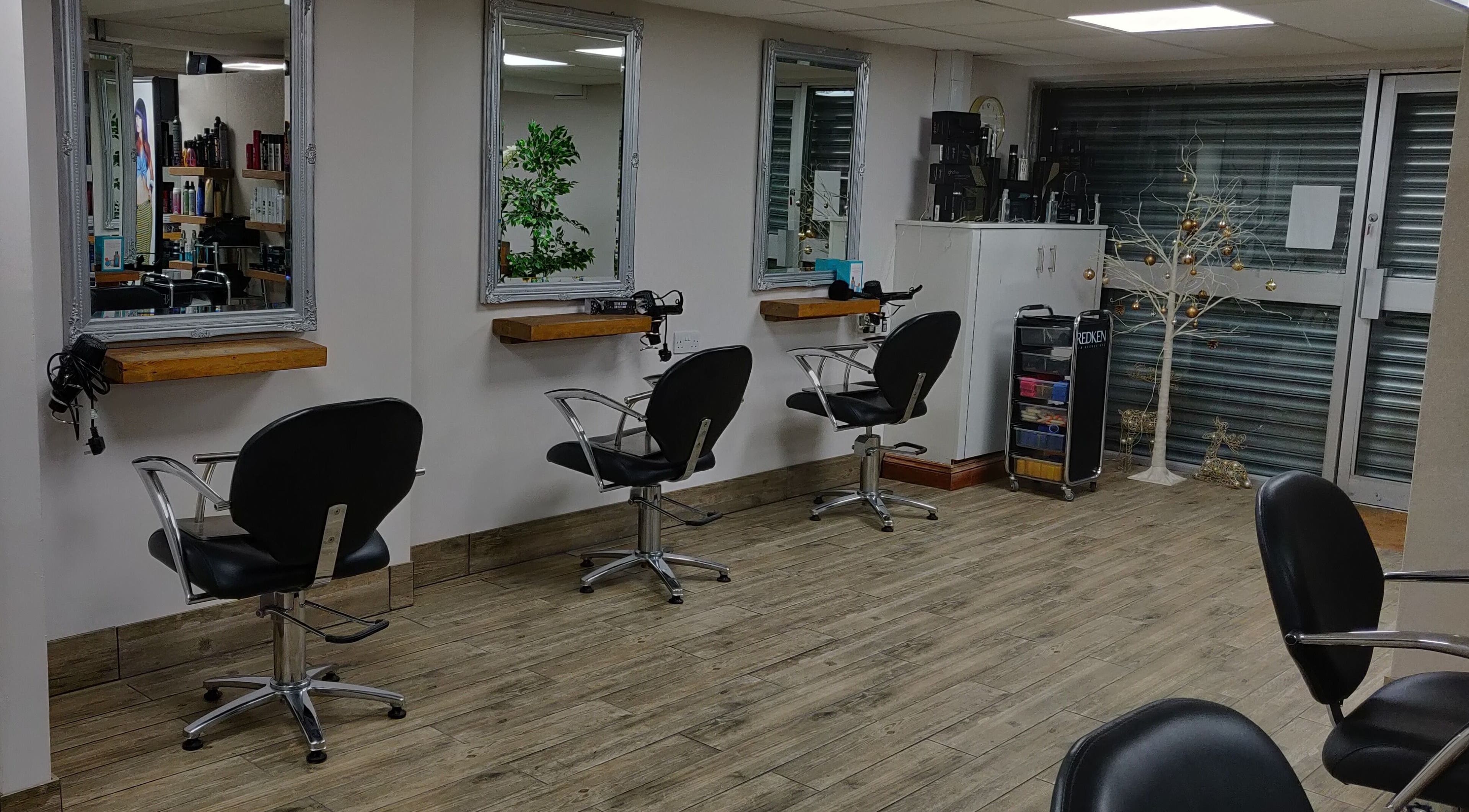 Modern styling stations at Mane Creations in Colchester, England, GB, showcasing professional salon setup.