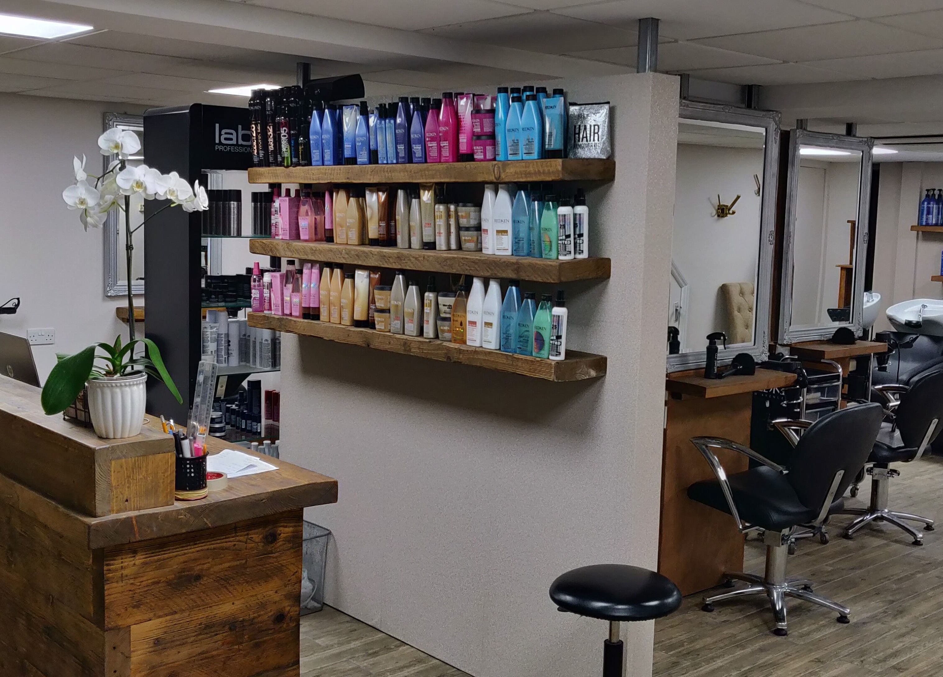 Chic salon interior at Mane Creations, Colchester, England. Features styling stations and diverse hair products.