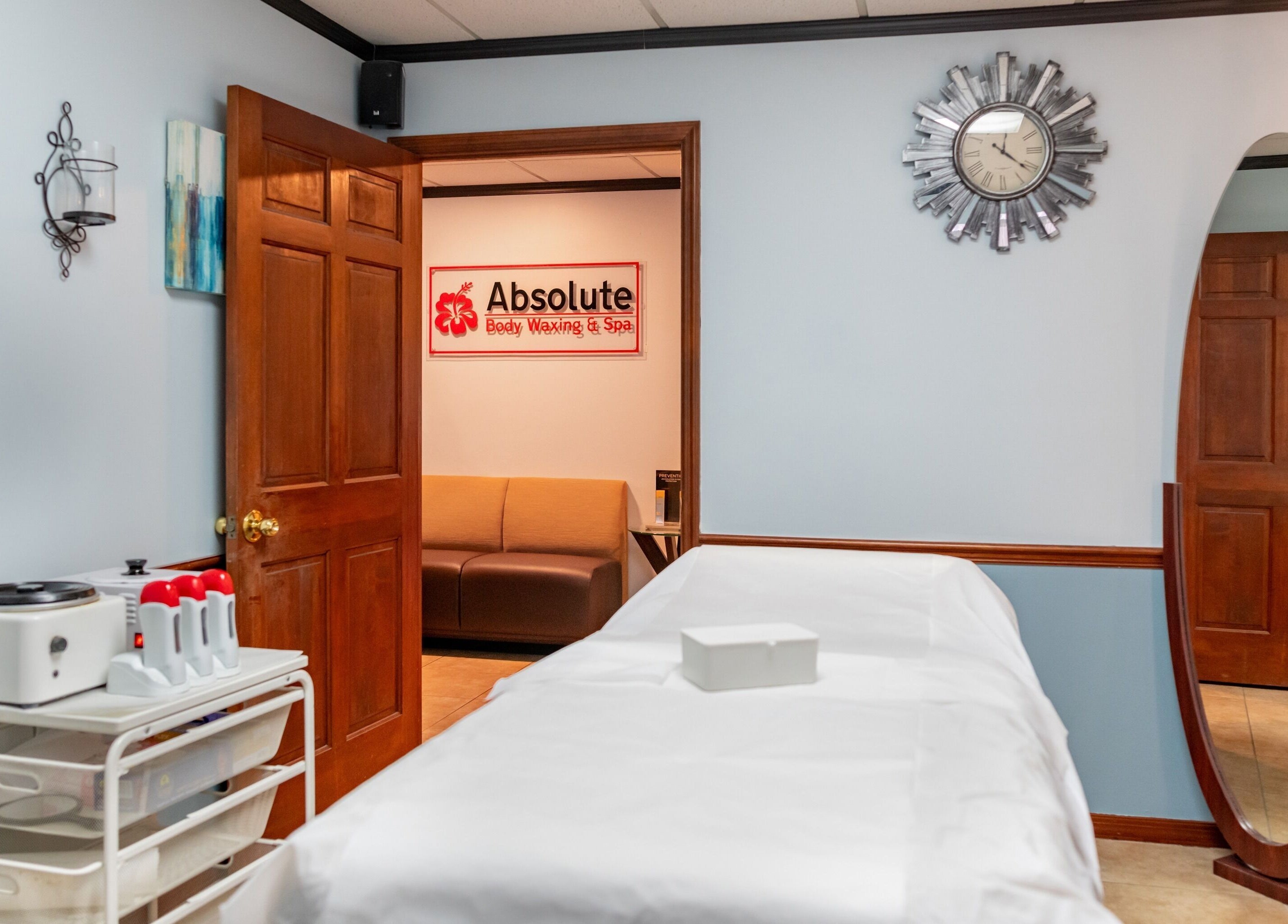 Tranquil spa room at Absolute Body Waxing and Spa, Winter Park, Florida, US with massage table and elegant decor.
