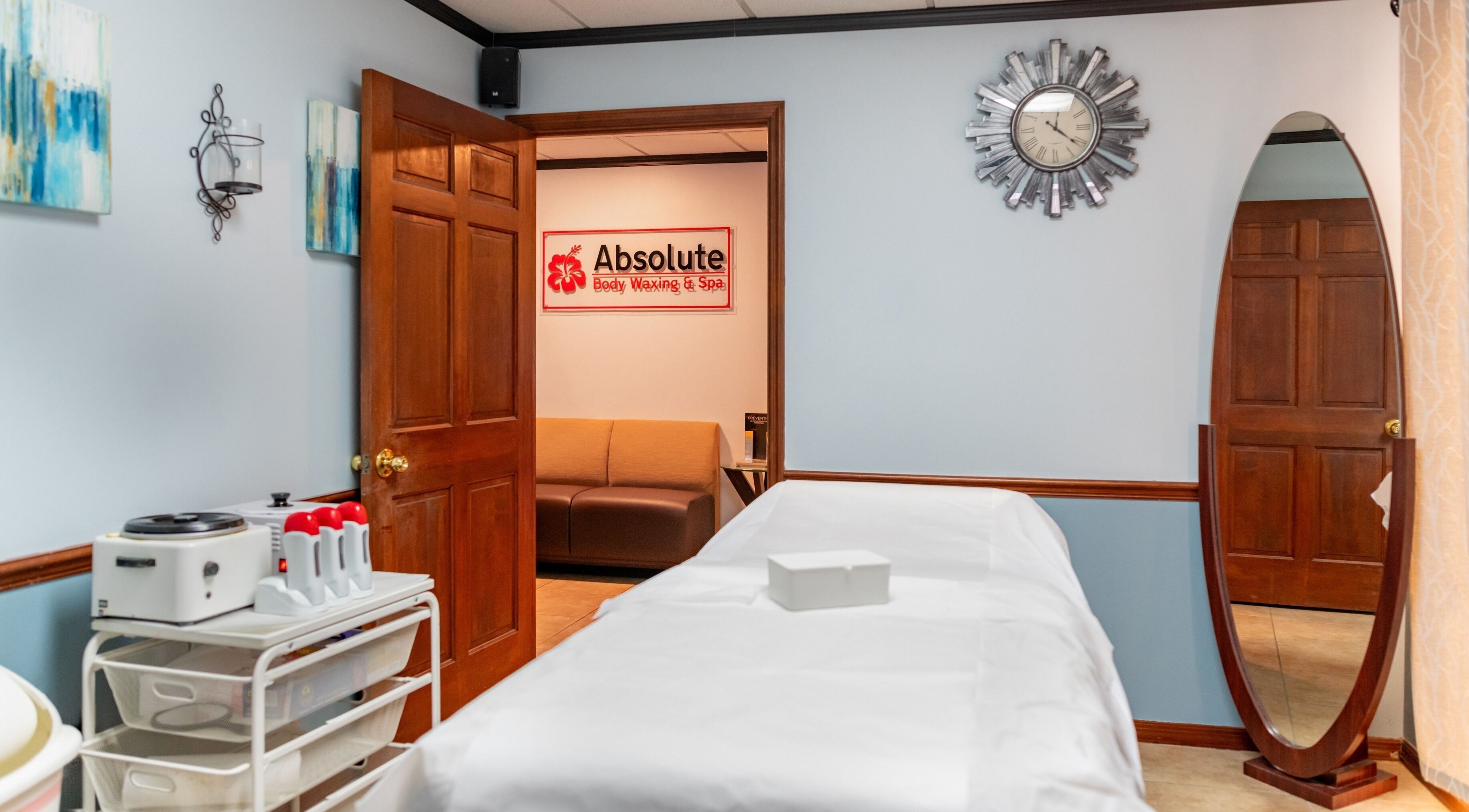 Tranquil spa room at Absolute Body Waxing and Spa, Winter Park, Florida, US with massage table and elegant decor.