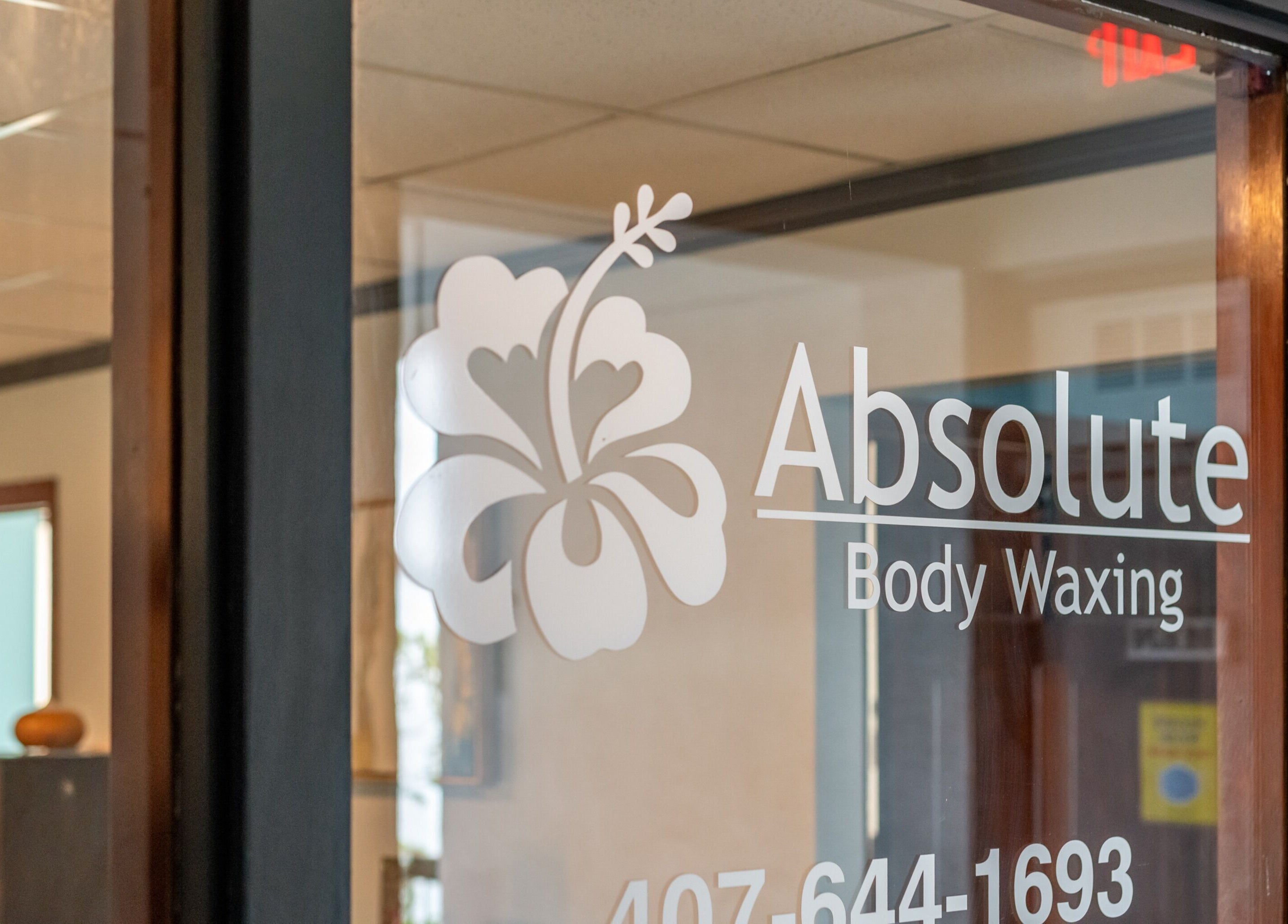 Elegant glass door sign for Absolute Body Waxing and Spa located in Winter Park, Florida, US
