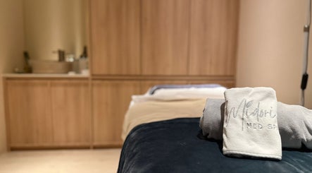 Relaxing treatment room at Midori Med Spa, Singapore, SG with branded towels.