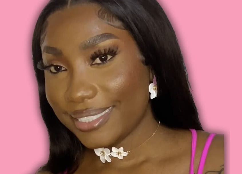 Close-up of a smiling woman with jewelry at Dime Divine Looks, Kingston, St. Andrew Parish, JM.