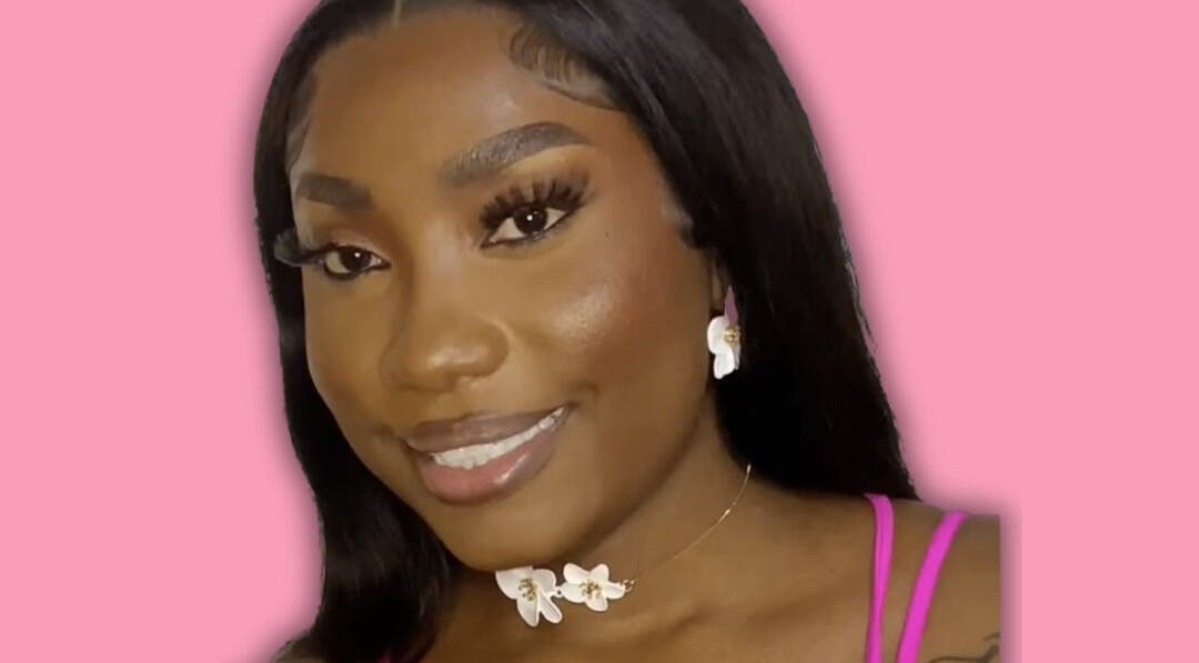 Close-up of a smiling woman with jewelry at Dime Divine Looks, Kingston, St. Andrew Parish, JM.