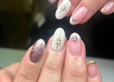 Elegant celestial nail art at Isa's Nail Boutique, Dublin, County Dublin, IE. Features gold stars and moons.