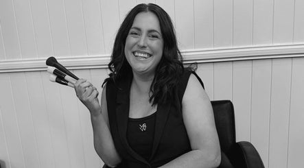 Smiling makeup artist holding brushes at Colestè Twilley Makeup, Crows Nest, Queensland, AU.