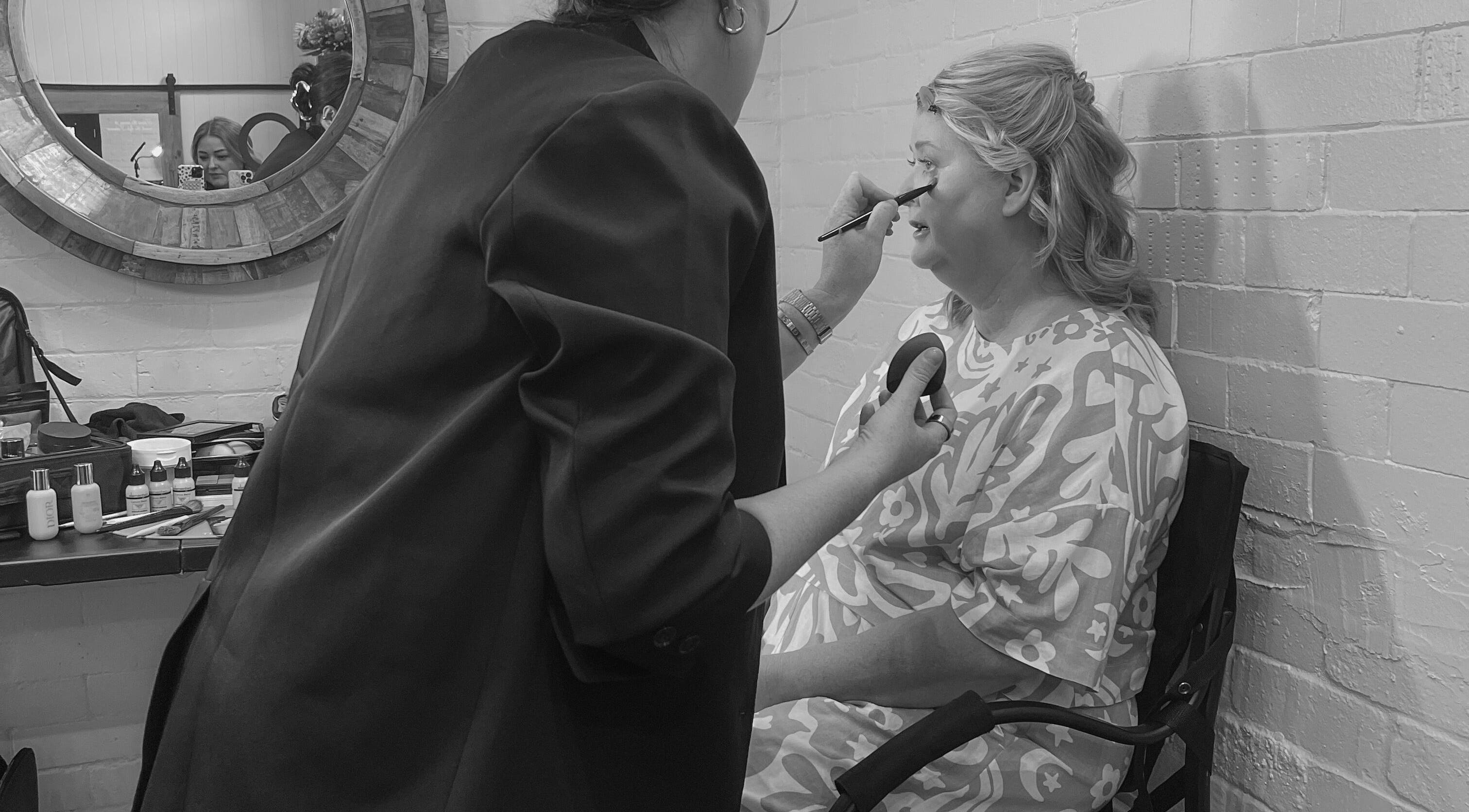 Makeup artist at Colestè Twilley Makeup, Toowoomba Region, applies eyeshadow to client.