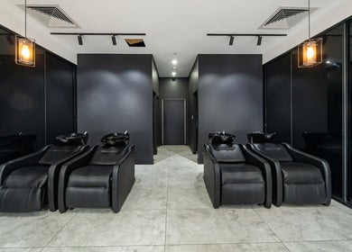 Modern hair washing station at Envy Hair and Beauty, Five Dock, New South Wales, AU with elegant black chairs.