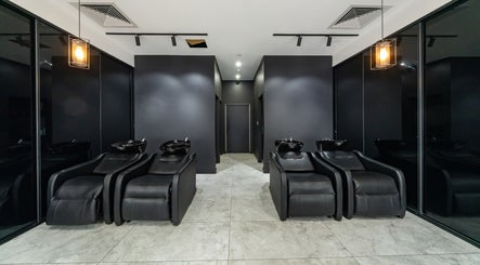 Modern hair washing station at Envy Hair and Beauty, Five Dock, New South Wales, AU with elegant black chairs.