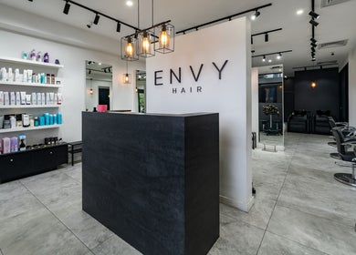Modern interior of Envy Hair and Beauty, Five Dock, New South Wales, AU showcasing chic design and styling chairs.
