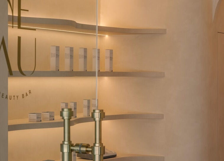 Chic interior of NEAU Beauty Bar in Singapore SG, showcasing minimalist design and product displays.
