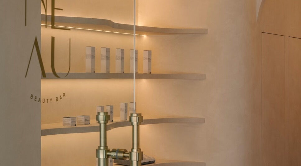 Chic interior of NEAU Beauty Bar in Singapore SG, showcasing minimalist design and product displays.