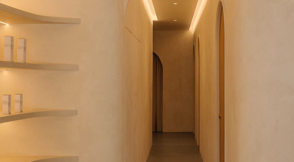 Elegant hallway at NEAU, Singapore, Singapore, SG, featuring soft lighting and curved shelves.
