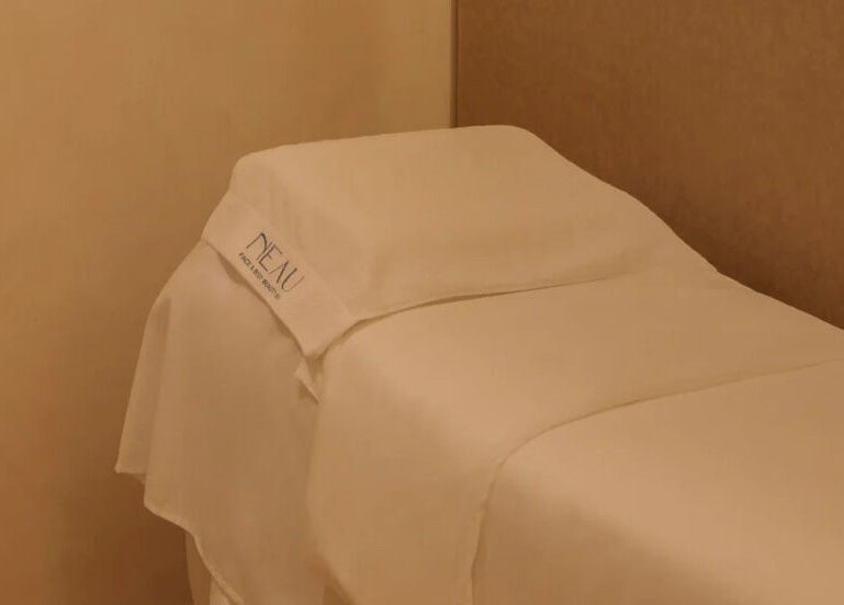 Luxurious treatment bed at NEAU, Singapore, Singapore, SG offering a tranquil spa experience.