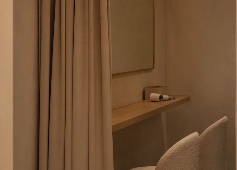Cozy makeup station at NEAU, Singapore, SG with beige curtains and elegant decor.